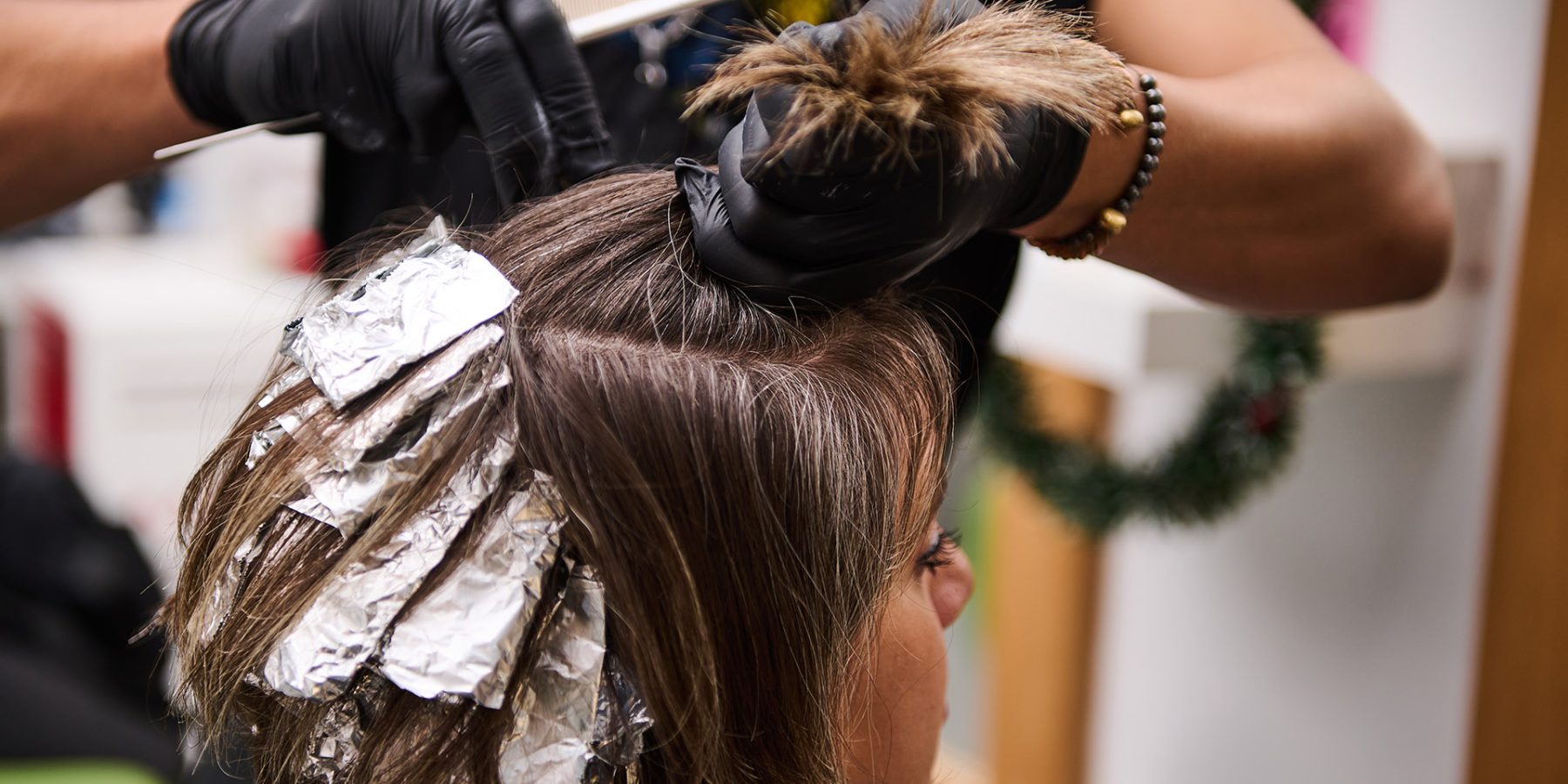 Professional,Hair,Treatment,And,Applying,Highlights,To,A,Woman's,Hair Professional hair treatment and applying highlights to a woman's hair in a modern beauty salon. High-quality hairdressing services