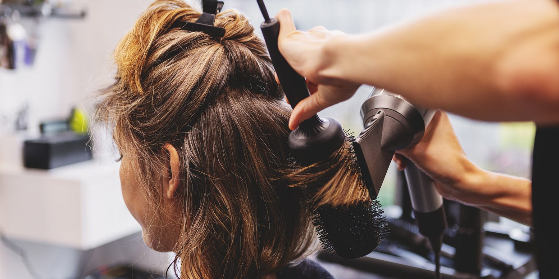 Woman,Receiving,Professional,Haircut,And,Styling,In,Beauty,Salon,By Woman receiving professional haircut and styling in beauty salon by hairdresser. Hair care ritual, beauty treatment and pampering concept